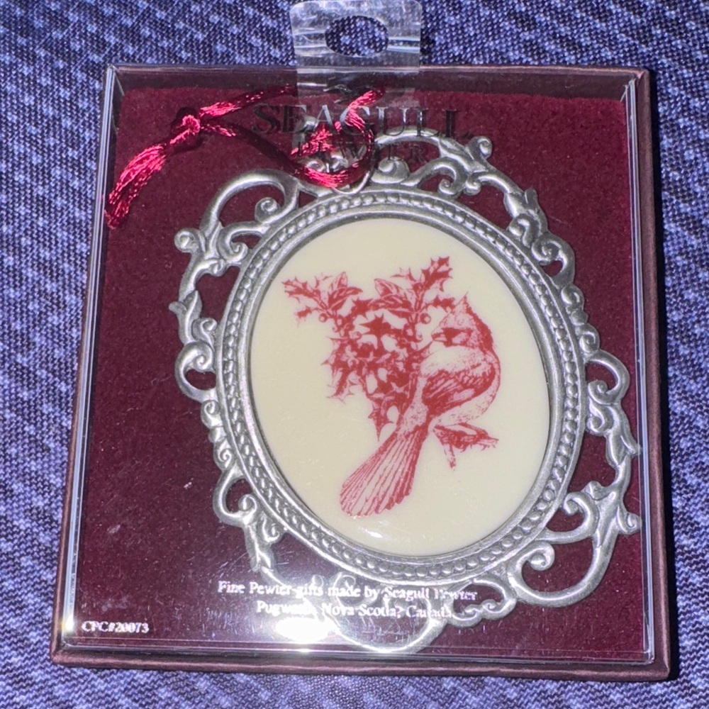 Seagull Pewter Christmas ornament featuring a bird and holly design